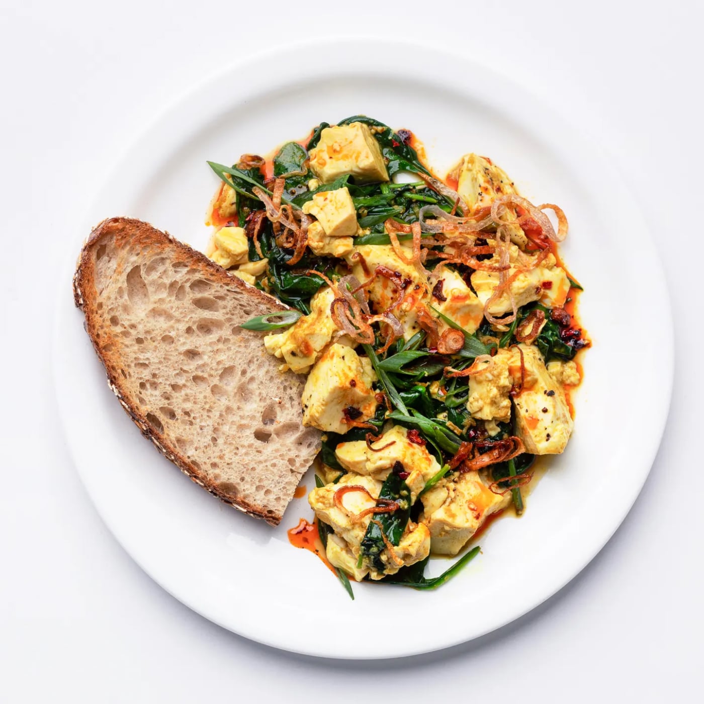 Image of Ginger-Scallion Tofu Scramble With Spinach and Chili Oil